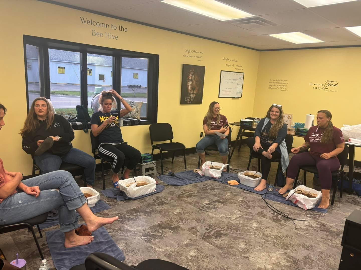 Group gathered for fellowship in the yellow-walled Busy B's office in Birch Run