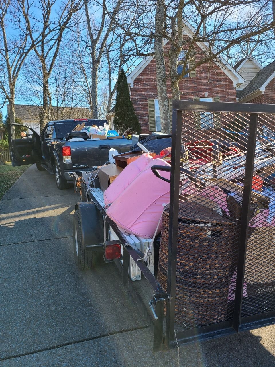 Matt's Haul it All pickup and trailer loaded with household items on a neighborhood street