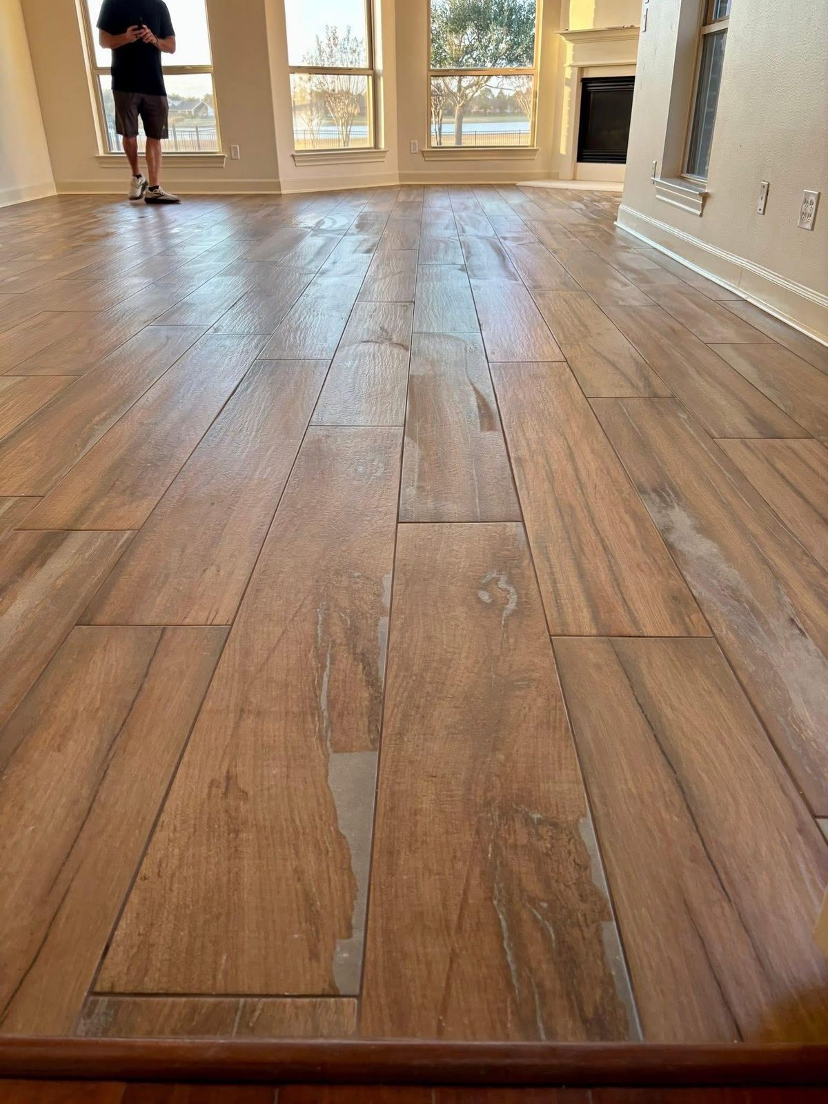 Wood-look plank tile floor running through a bright living room in Pearland