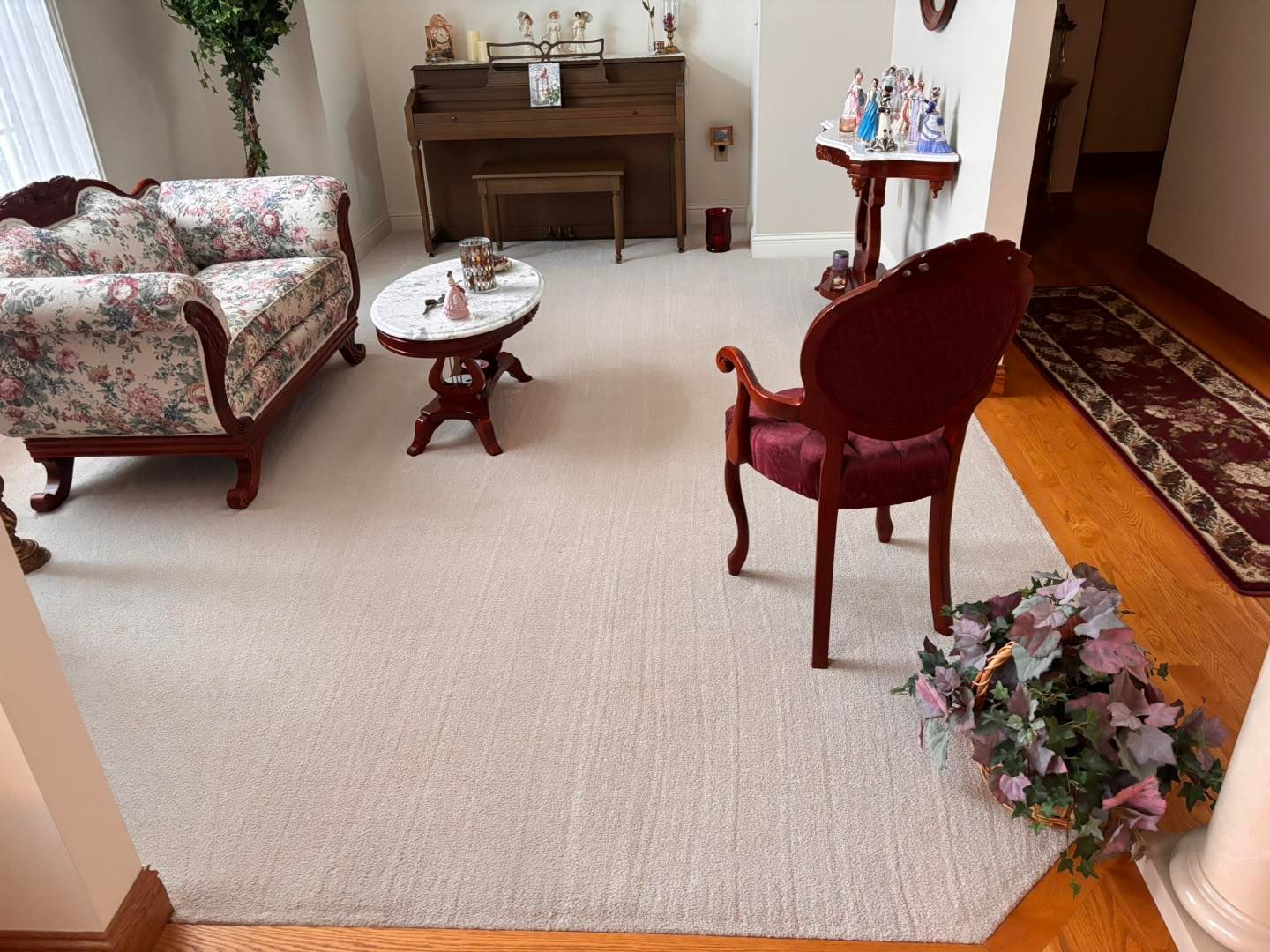 Formal living room with a clean rug and polished wood floor after a Busy B's residential cleaning