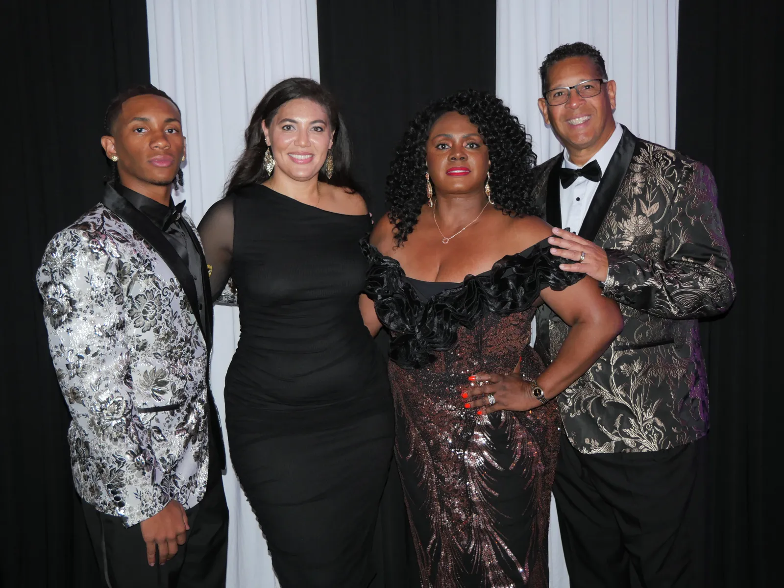 Black and white glam booth portrait of guests dressed for a formal event