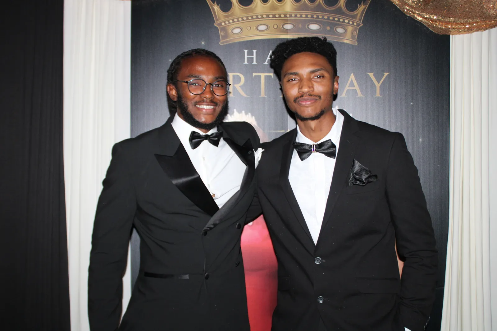 Black and white glam portrait of two guests in suits