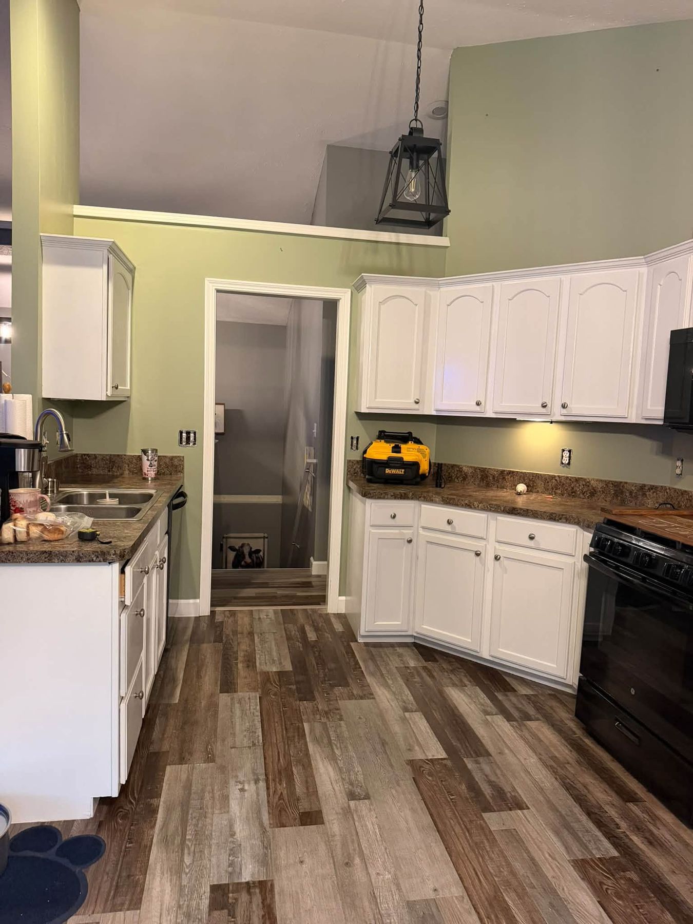 Kitchen with refinished white cabinets and sage green walls in La Porte County, Indiana by KJ Painting and Finishing