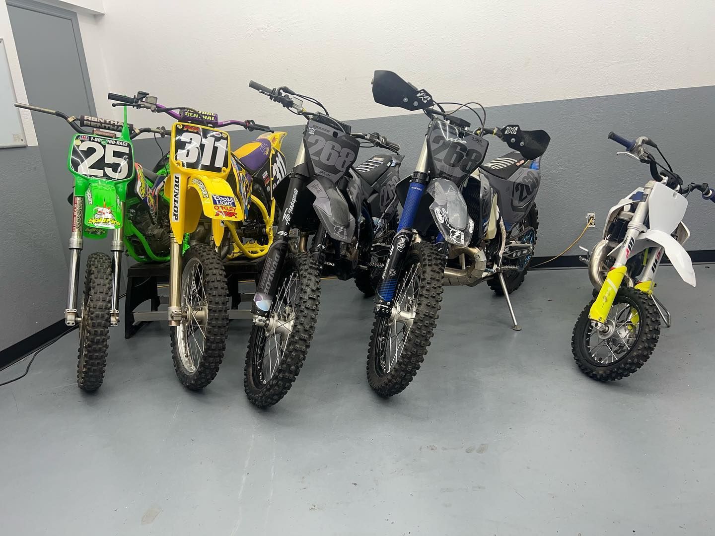 A row of dirt bikes in for service