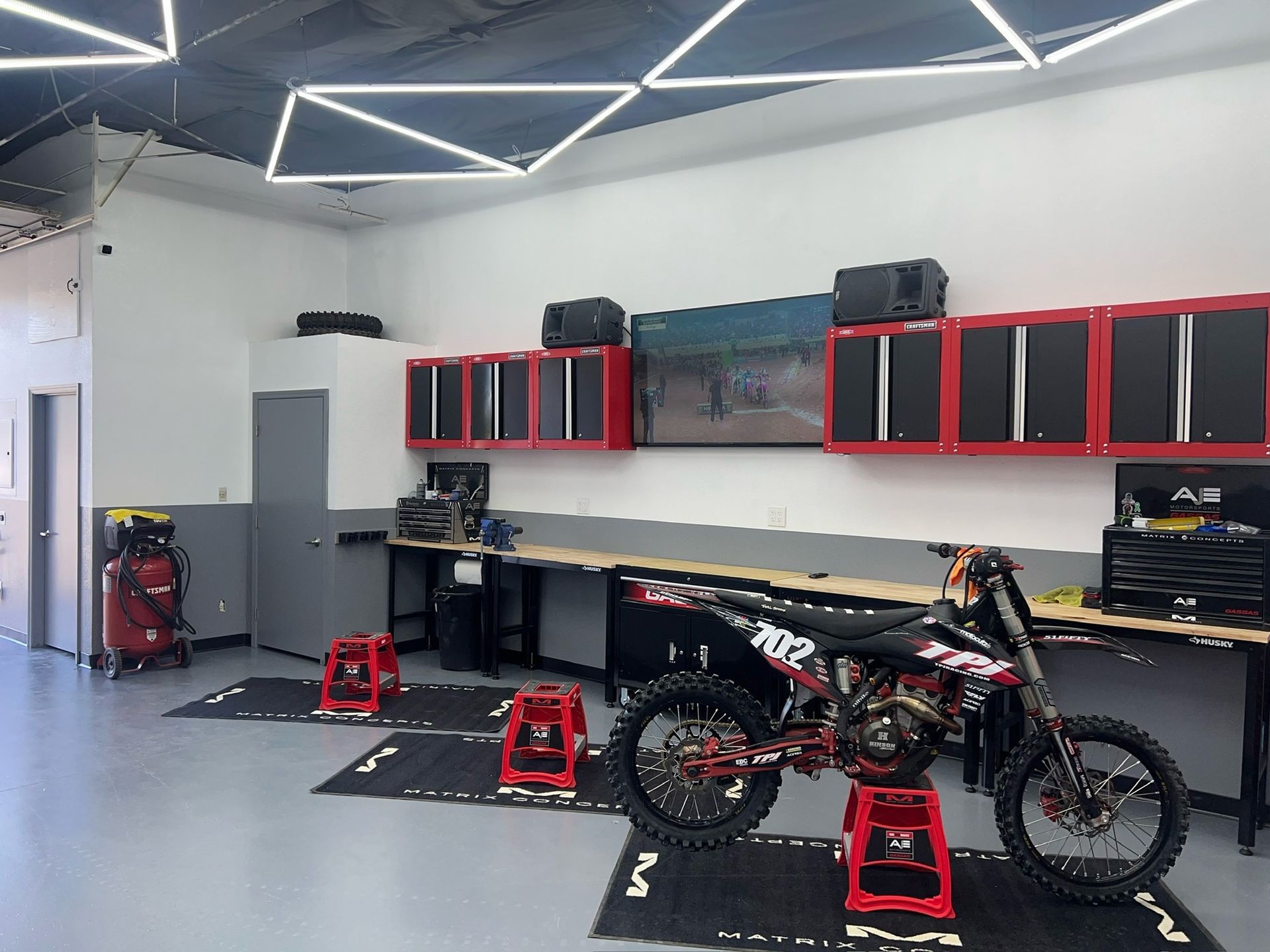 Dirt bike on a stand in the Road Runner Motorsports service bays
