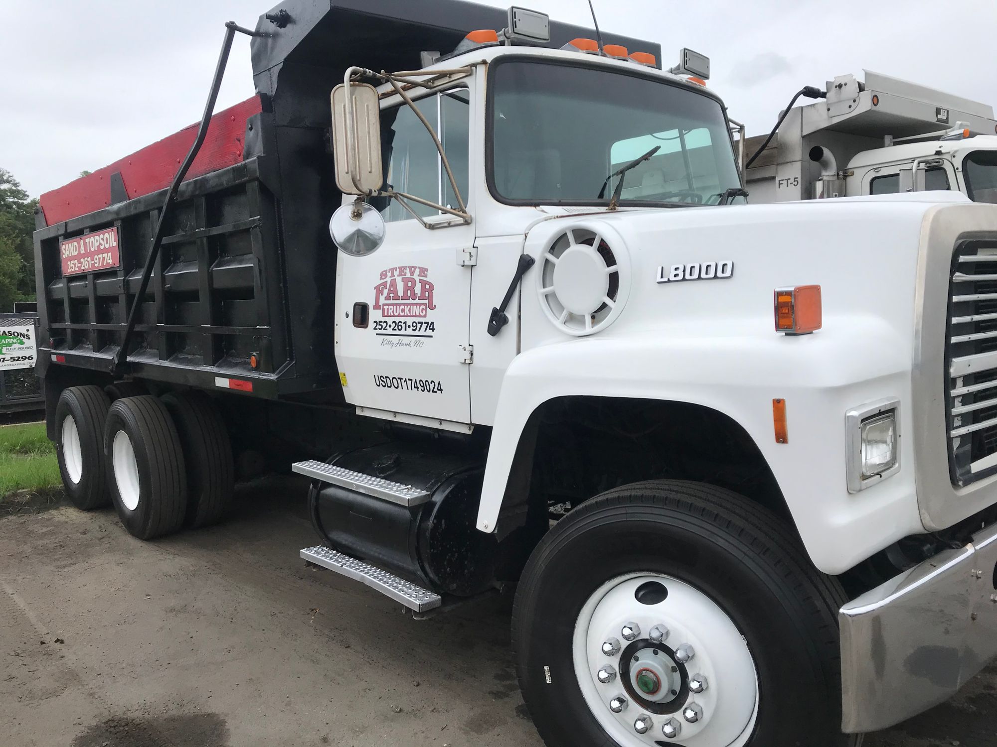 White Farr Trucking Ford L8000 dump truck used for rock delivery