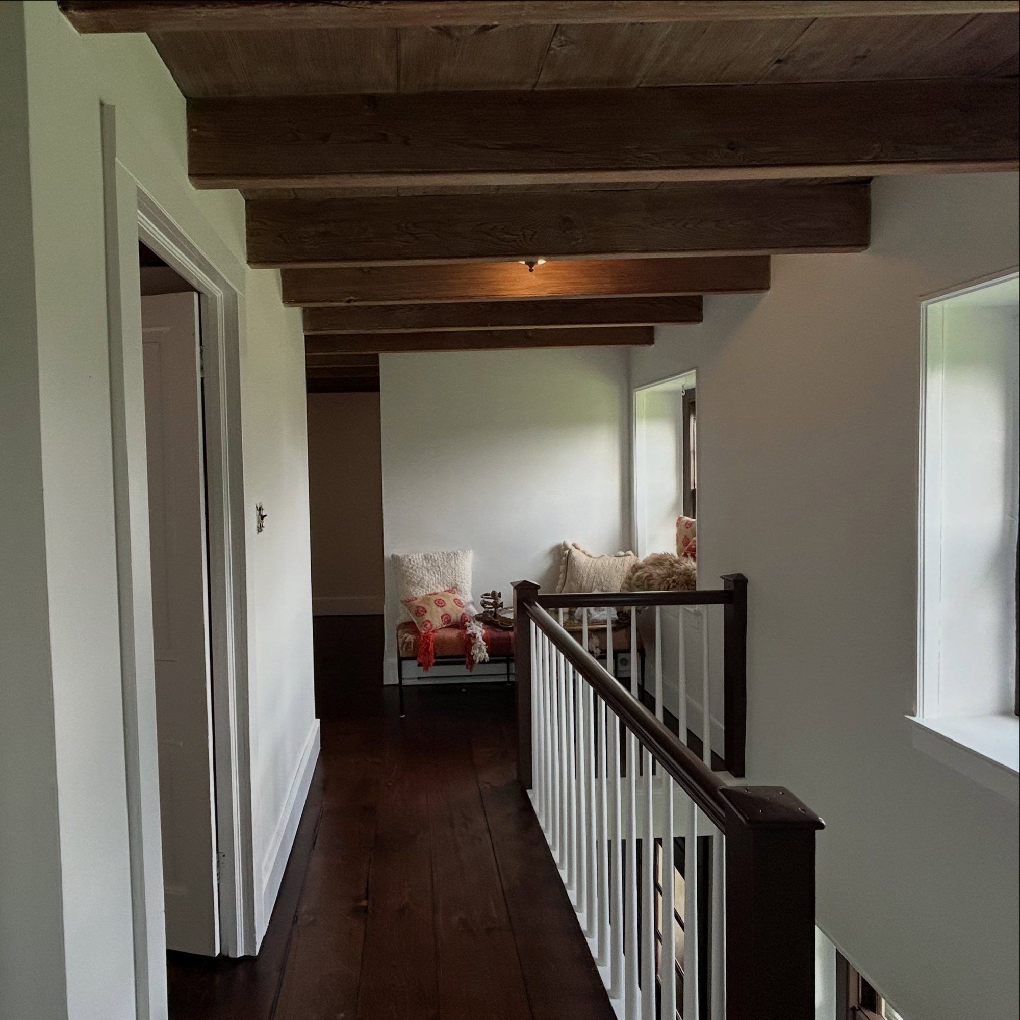 Farmhouse room finished in Portola Roman Clay under dark beams