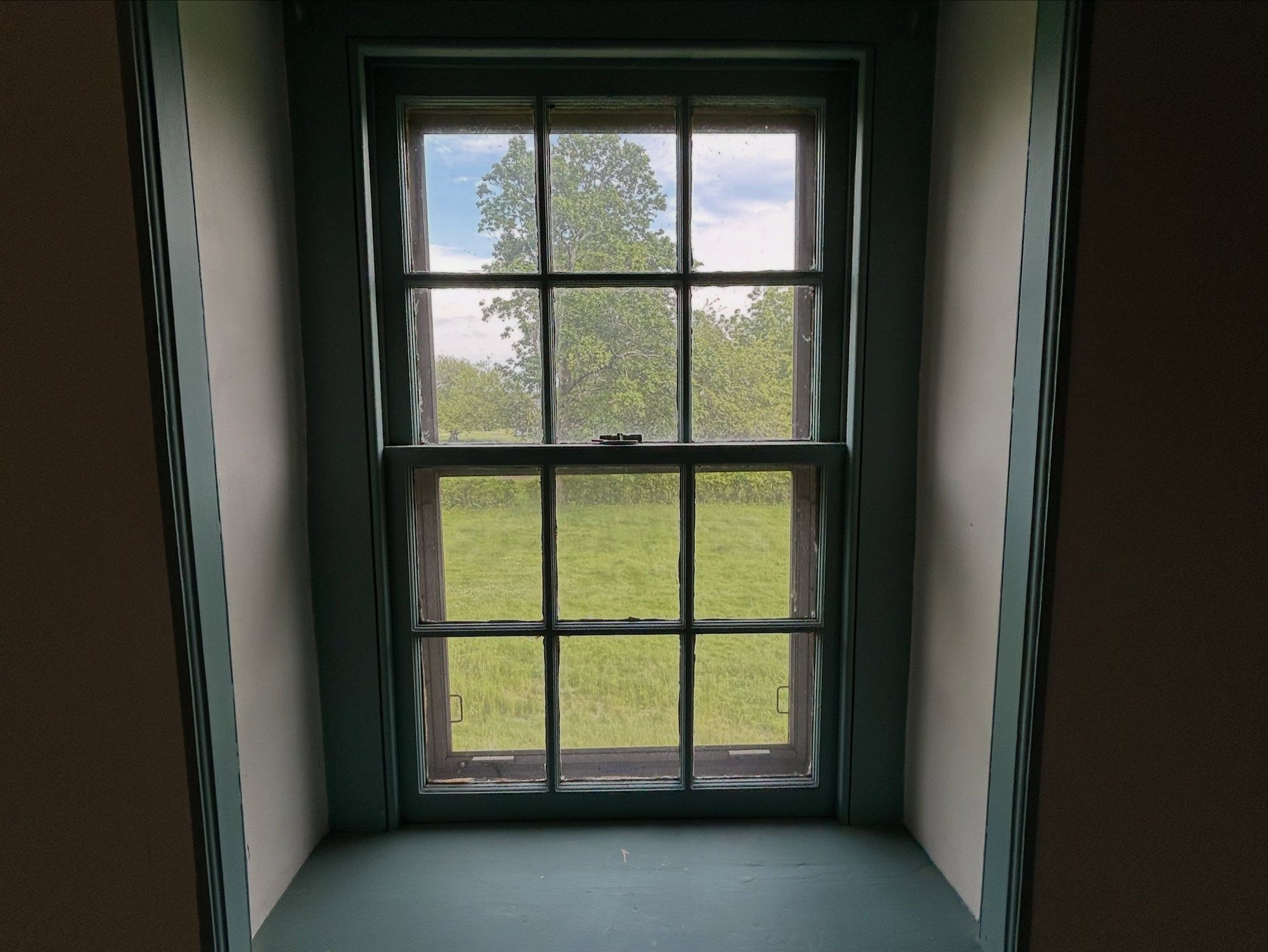 Restored farmhouse window sash finished in a deep green satin enamel