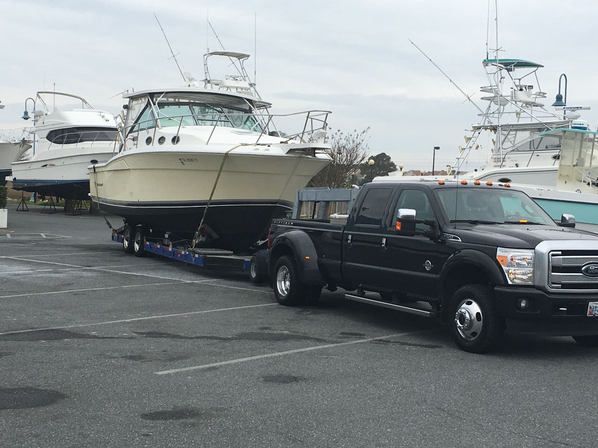 Turner Yacht Services F-350 with a sportfish loaded on the hydraulic trailer, ready to leave the yard