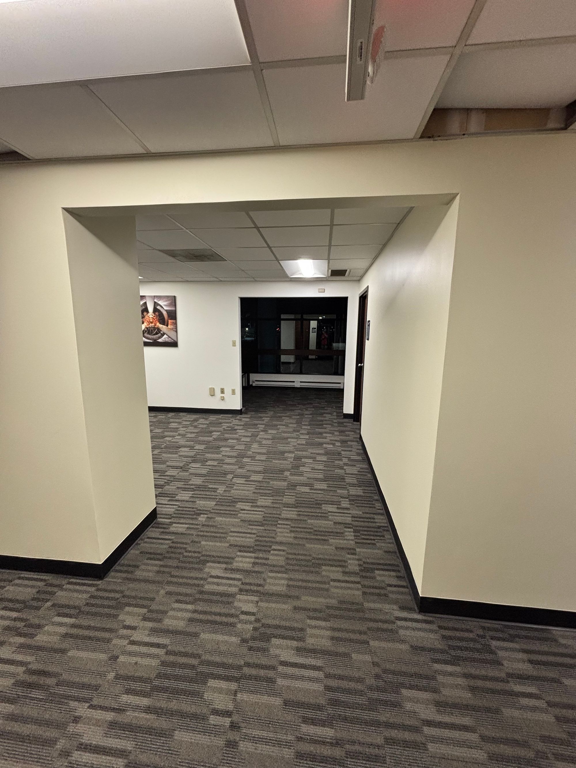 Office hallway with freshly painted walls and new carpet tile