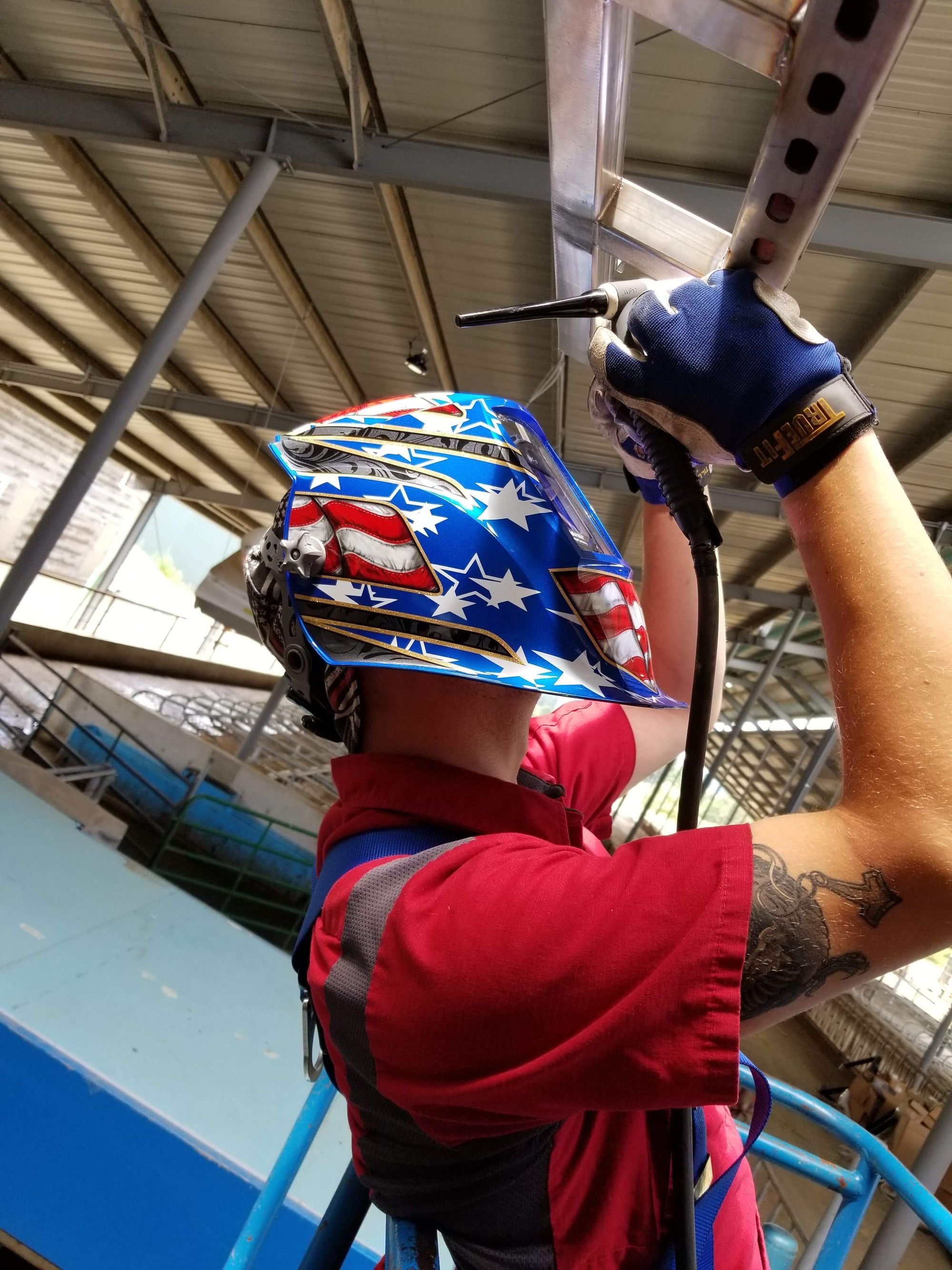 Caleb Erickson TIG welding overhead on a dairy installation