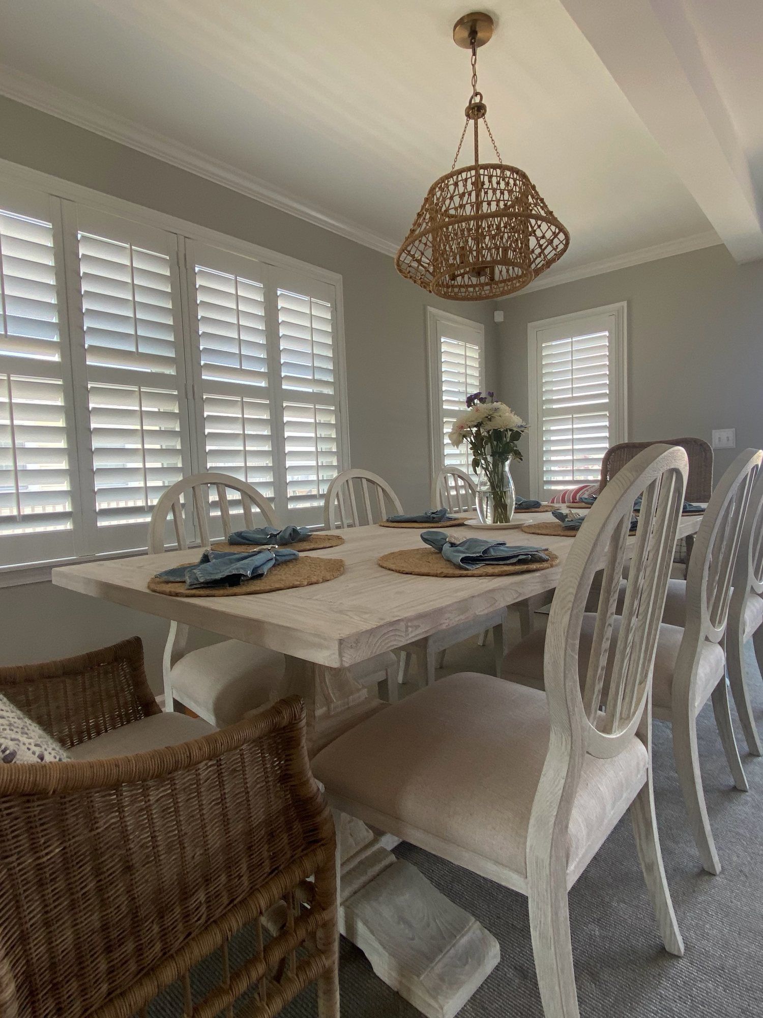 Dining room with fresh white walls, painted trim and plantation shutters