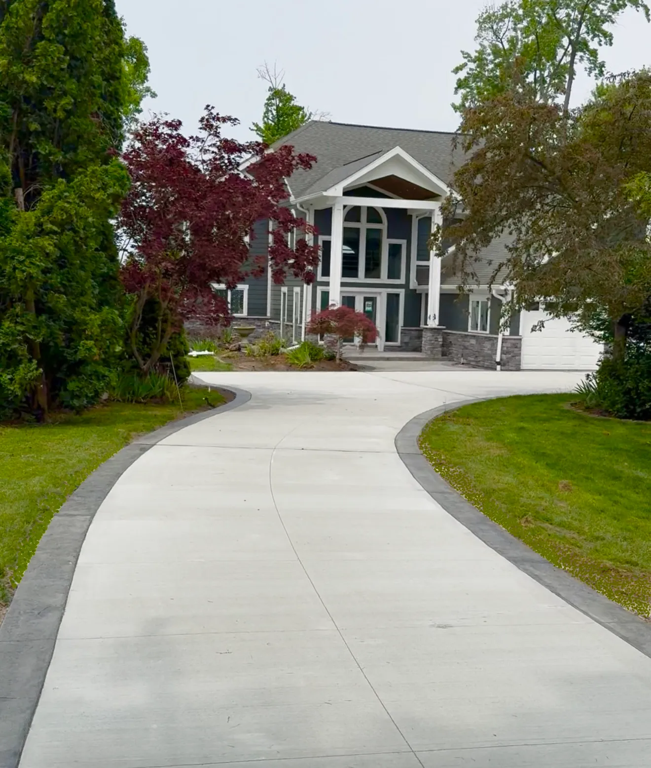 New concrete driveway poured in front of a Metro Detroit home