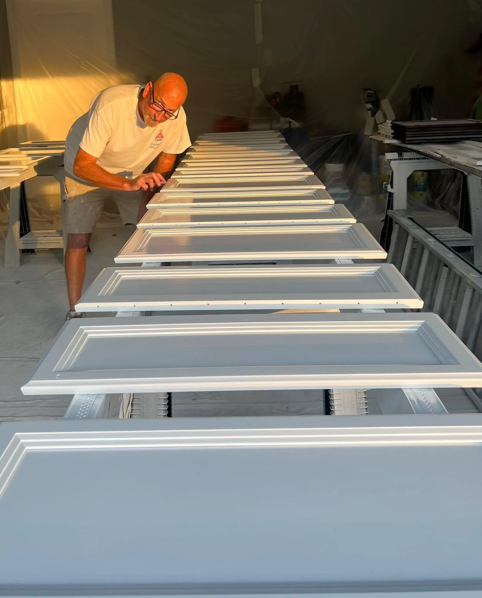 Ryan Garrity spray finishing cabinet doors for a Largo kitchen