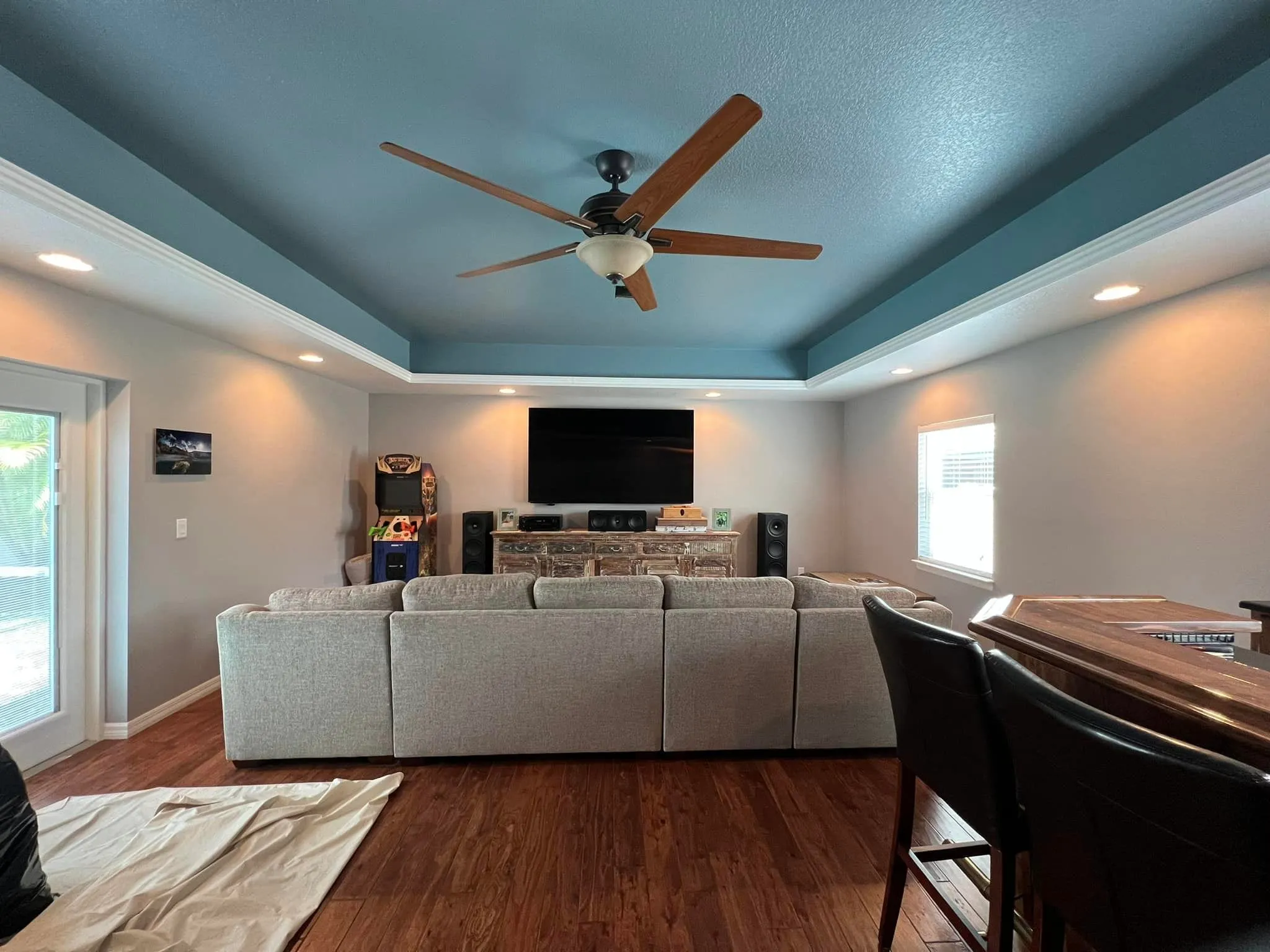 Clearwater living room repainted with a soft blue tray ceiling and warm neutral walls