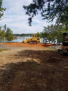 Our Skid Steer Work service provides precise and efficient landscaping, grading, and earthmoving solutions for homeowners, ensuring your outdoor spaces are expertly prepared for any construction or improvement project. for Fisher Hauling And Grading in Rockingham County, NC