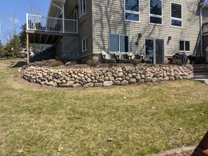 A retaining wall is a structure that holds back earth or other material from moving downhill. Retaining walls are typically constructed of masonry, stone, brick, or concrete. for Chetek Area Landscaping LLC in Chetek Area, WI