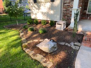 Multiple flowerbeds with annual and perennial plants, mulch, and edging; 1000-3000 square feet of sod. Pricing: $3,200-$5,500
 for Ozark Lawn Professionals LLC in Lowell, AR