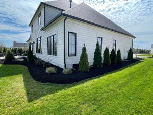 Our Mulching service helps homeowners improve the health and appearance of their outdoor spaces by applying a layer of protective materials to retain moisture, suppress weeds, and nourish plants. for Kunkle & Sons Property Maintenance in New Franklin, OH