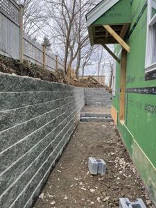 Our Retaining Wall Construction service expertly designs and builds durable retaining walls that enhance stability, prevent soil erosion, and beautifully integrate with your landscaping to increase both functionality and aesthetic appeal. for Tk Construction in Gloucester, MA
