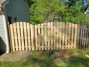 Enhance your home's appeal with our custom wood gates, crafted for durability and elegance. Our expert team ensures precise installation, adding security and charm to complement any outdoor space seamlessly. for Premier Fence in Marietta, GA