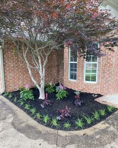 Flower bed cleanups include trimming all bushes and plants, pulling weeds, installing new mulch, and hauling off all debris. Starting at $375 for Ozark Lawn Professionals LLC in Lowell, AR