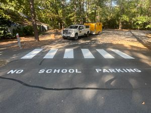 Our Asphalt Marking service enhances safety and aesthetic appeal by providing clear, durable line markings for driveways and parking areas, ensuring precise navigation while complementing the overall appearance of your property. for Payne's Pavement Marking in Warrenton, VA