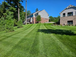Our Lawn Maintenance service ensures your yard stays lush and healthy with expert mowing, trimming, and fertilization. Enjoy a pristine lawn year-round without the hassle of upkeep or equipment. for Howell Hardscape Inc in Brighton, MI