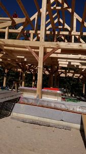 Our Timber Framing service offers exquisite craftsmanship for your home, expertly integrating structural woodwork with unique tile accents, providing both strength and beauty to elevate any remodeling project. for Dresser Timber Frames in Dedham, ME