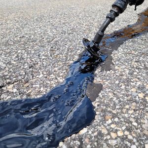 Our Crack Sealing service expertly repairs and seals cracks in your asphalt driveway, preventing water damage and extending its lifespan, ensuring a smooth, long-lasting surface for your home. for Matthew's Enterprise in Claremont, NH