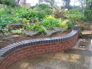 Our retaining wall construction service offers homeowners a durable and professionally built solution to prevent soil erosion, create terraced areas, and enhance the overall aesthetics of their outdoor spaces. for All in One Masonry in Dedham, MA