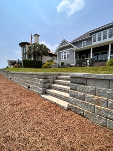 Our expert team constructs durable and attractive retaining walls to prevent soil erosion and create level surfaces in your outdoor space. Enhance the functionality and aesthetics of your property with us. for Djosey Landscapes in Wilmington, NC