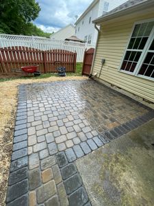 Our Paver Patios service specializes in creating beautiful and durable outdoor living spaces using high-quality materials, expert craftsmanship, and attention to detail. for DLS Landscaping in Charlotte, NC