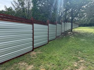 Enhance your property's security and aesthetics with our durable corrugated metal fence installations, offering expert craftsmanship and customizable designs tailored to complement any home while ensuring long-lasting protection. for Ansley Staining and Exterior Works in New Braunfels, TX