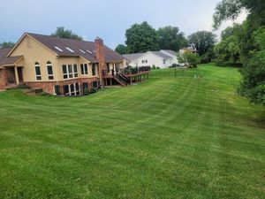 Our Lawn Maintenance service ensures your yard stays lush and healthy with expert mowing, trimming, and fertilization. Enjoy a pristine lawn year-round without the hassle of upkeep or equipment. for Howell Hardscape Inc in Brighton, MI