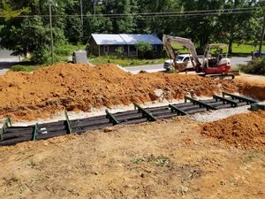 Our Backhoe Services provide efficient and reliable digging and excavation solutions for homeowners in need of septic system installations, repairs, or sewer line replacements. for Septic & Sewer Solutions in Buford, GA