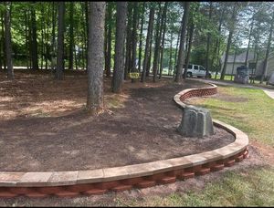 Enhance your outdoor space with our expert retaining wall construction services, providing lasting durability and aesthetic appeal while effectively managing soil erosion and creating functional, beautiful landscapes tailored to your home's needs. for JMLP Lawn & Landscaping in Charlotte, NC