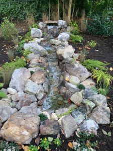 Transform your outdoor space with our Waterfalls & Water Features service, creating a tranquil oasis that enhances natural beauty, fosters relaxation, and elevates the overall aesthetic of your landscape. for Howerton’s Landscaping in Clemmons, NC