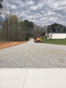 Our Roadbeds service provides expertly crafted foundations for driveways, ensuring durability and stability with precise excavation techniques to enhance your property's access while adding lasting value and appeal. for CST Dirt Solutions in Rowan, NC