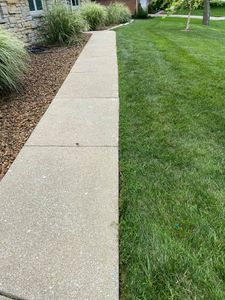 Our Edging service provides precise and clean lines around flowerbeds, walkways, and driveways to enhance the overall appearance of your lawn. for Davidson Lawn Care LLC in Greensburg, IN