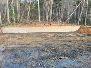 Our company specializes in expert retaining wall construction services to help protect your property from erosion, create aesthetic appeal, improve landscape functionality, using heavy equipment for precise installation. for Elias Grading and Hauling in Black Mountain, NC