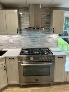 Our Kitchen Backsplash service enhances your kitchen's aesthetic appeal by professionally installing stylish and durable backsplash options that complement the overall design. for Laura Mae Properties in Wolcott, CT