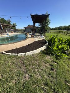 Enhance your garden's health and appearance with our professional mulch installation service, providing expert placement to retain soil moisture, suppress weeds, and enrich plant growth for a stunning outdoor space. for Fine Line Lawn Care & Landscaping in Aledo, TX