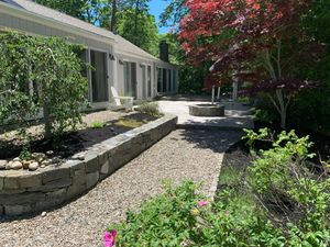 Our Retaining Wall Construction service enhances your outdoor space by providing durable and stylish structure solutions to prevent soil erosion, increase functionality, and add aesthetic appeal to your landscape. for Lawn Shark Landscaping in Monument Beach, MA