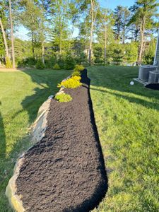 Enhance your garden with our professional mulch installation service, boosting curb appeal and soil health. We expertly apply high-quality mulch that conserves moisture, suppresses weeds, and enriches your landscape’s beauty. for GH Lawn Services in West Warwick, RI