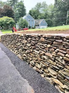 Our Retaining Wall Construction service ensures durable and aesthetically pleasing solutions tailored to your landscape needs, combining expert craftsmanship with high-quality materials for enhanced stability and visual appeal in your outdoor space. for Chaban Masonry in Athol, MA