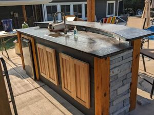 Our Outdoor Bars service offers homeowners the perfect addition to their outdoor kitchens, providing a stylish and functional space for entertainment and relaxation in their outdoor living area. for Sunset Outdoor Kitchens   in Hartsville, TN