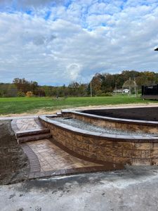 Enhance your outdoor space with our expert retaining wall construction service, providing durable support and stylish design to prevent soil erosion and create a beautiful, functional landscape in your yard. for DiSessa Landscape & Construction in Wantage, NJ