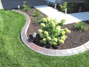 Our Mulch Installation service offers homeowners a convenient and efficient solution to enhance the appearance of their landscape, protect plants from harsh weather conditions, and suppress weed growth. for LB's Lawn and Snow, LLC in Saint Cloud, MN