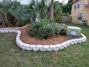 Enhance your landscape with our professional mulch installation service, offering expertly selected materials to boost curb appeal, retain moisture, suppress weeds, and nourish soil for a vibrant garden year-round. for Lawn Dogz Lawns & Landscaping in Tampa, FL